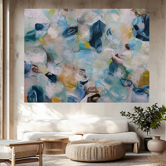 Abstract painting in a living room with a sofa and decor