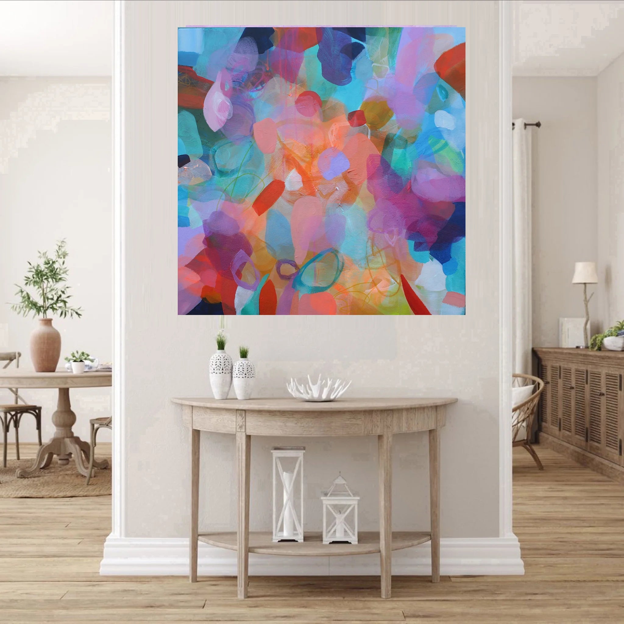 Colorful abstract painting on a wall in a living room setting.