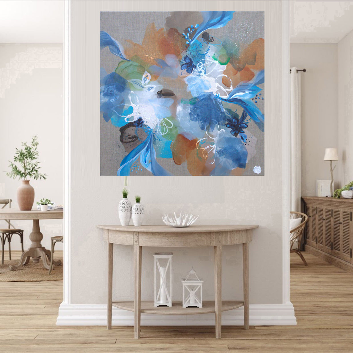 Abstract floral painting in a living room setting with a wooden table and decor.
