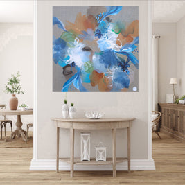 Abstract floral painting in a living room setting with a wooden table and decor.