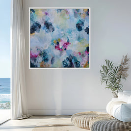 Colorful abstract painting on a wall in a room with a plant and window.