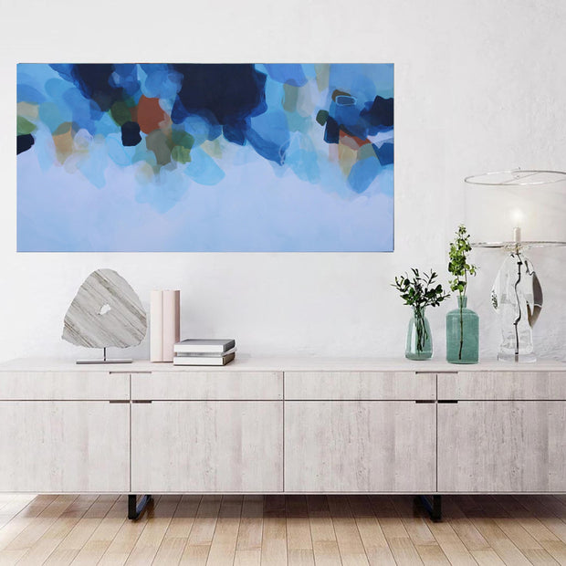 Modern living room with a sideboard, abstract painting, and decorative items.