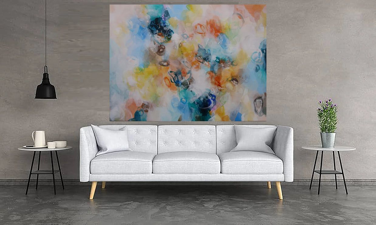 Modern living room with a white sofa, colorful abstract painting, and small tables.