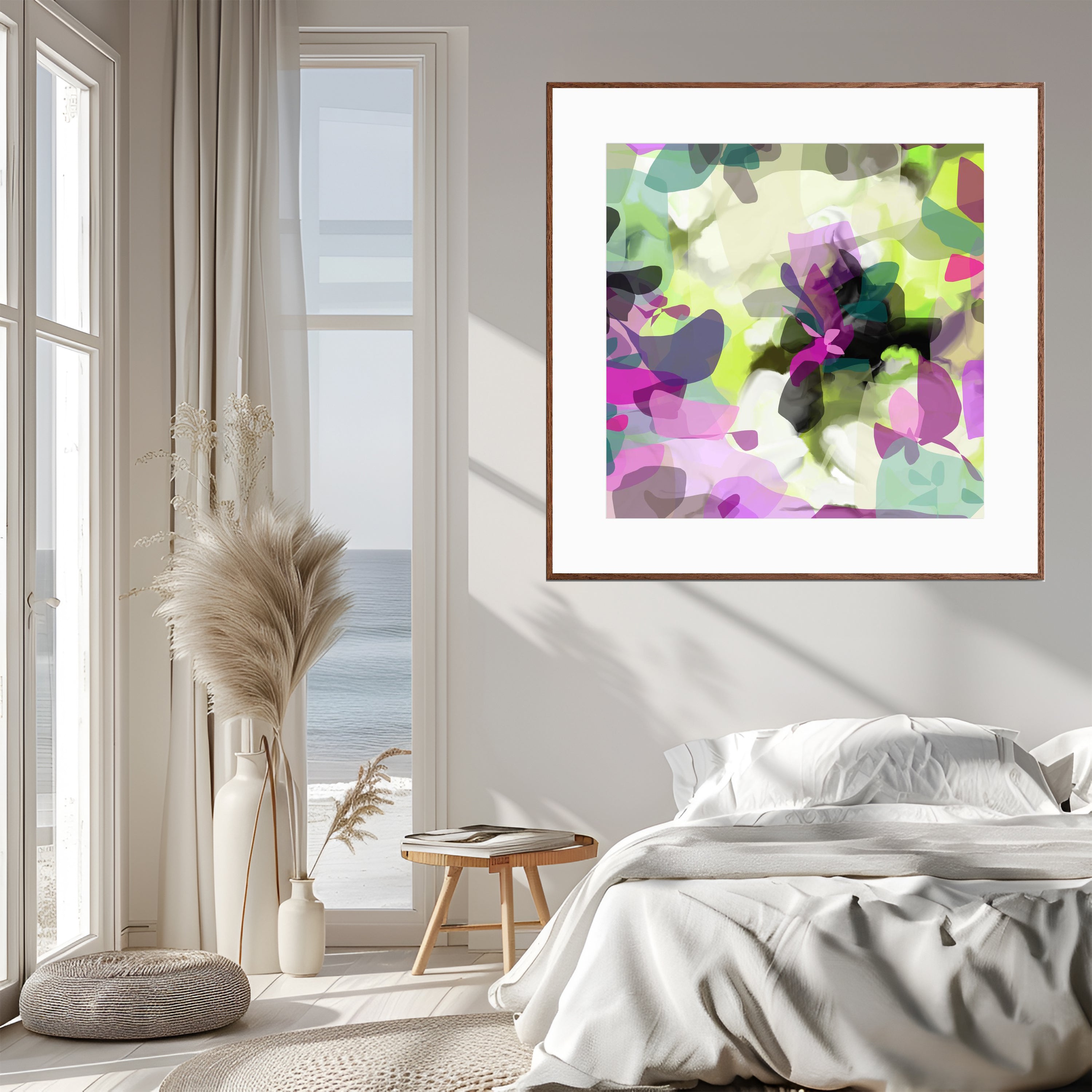 Framed abstract art piece on a wall above a bed with a window view.