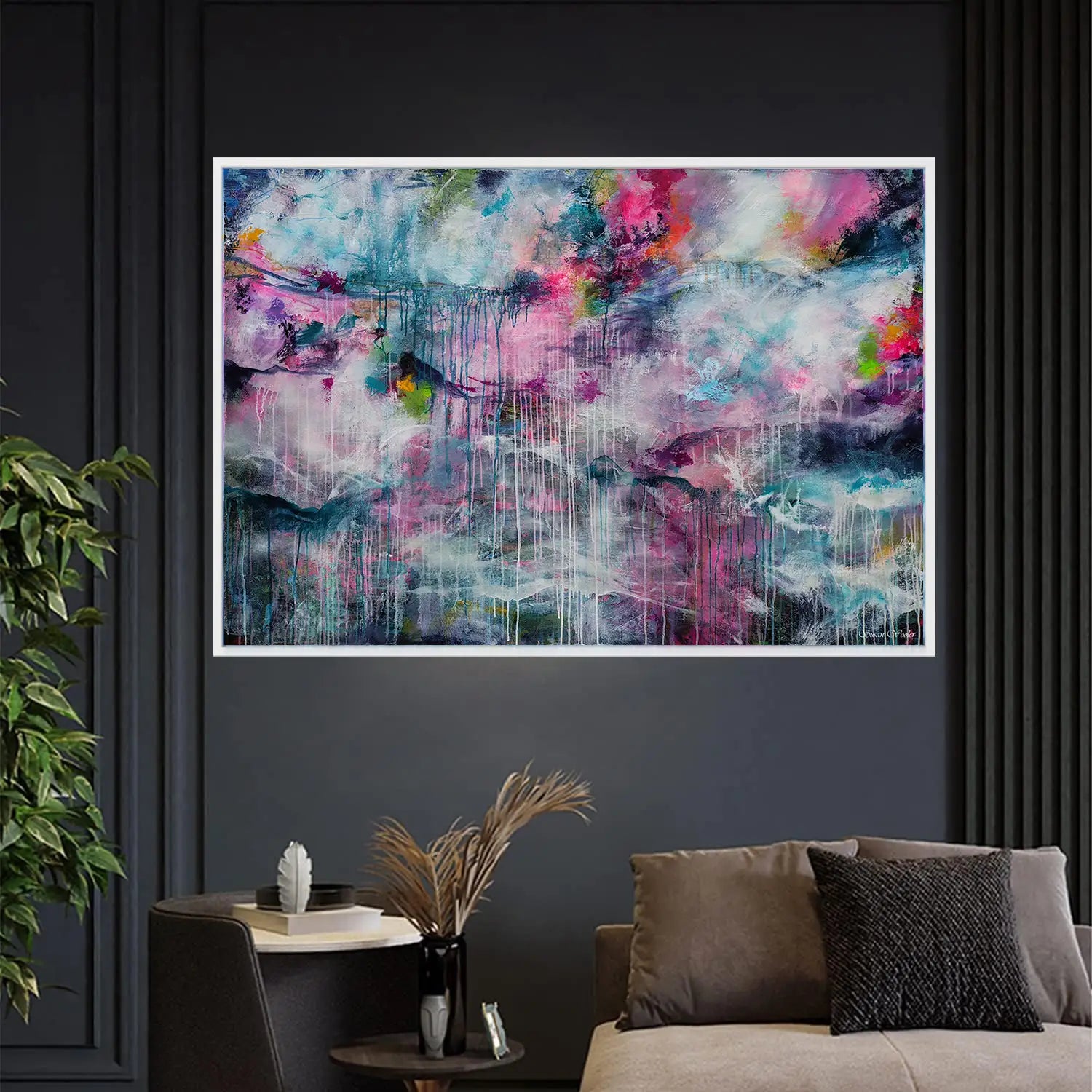 Abstract painting on a dark wall above a sofa with decorative elements.
