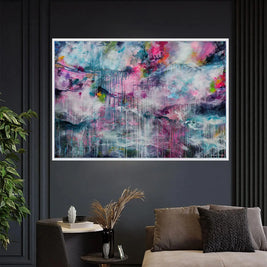 Abstract painting on a dark wall above a sofa with decorative elements.