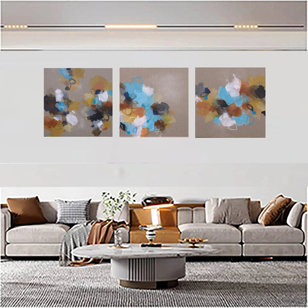 Three side-by-side images of colorful abstract art on a linen canvas background above sofa