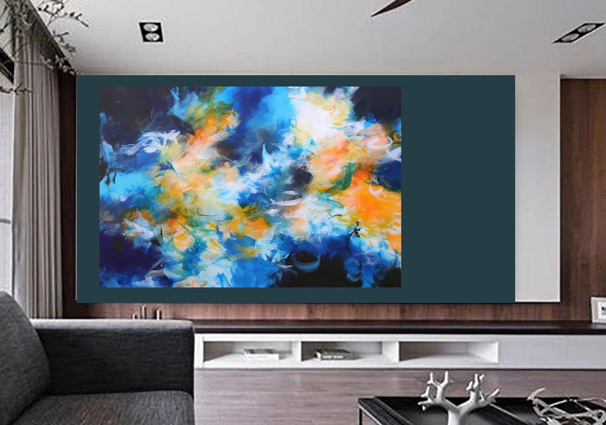 Modern lounge with a colorful abstract painting above a bed.