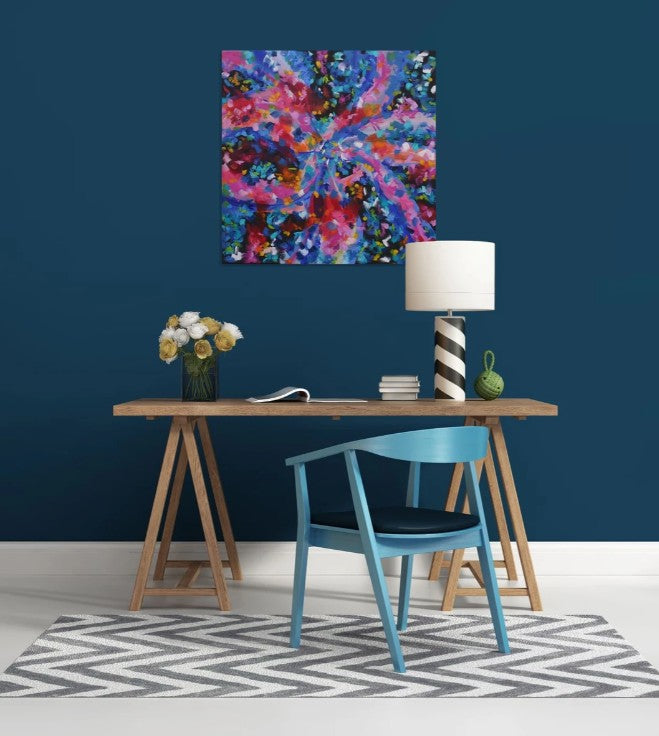 Modern interior with a colorful abstract painting on a blue wall, wooden table, and blue chair.