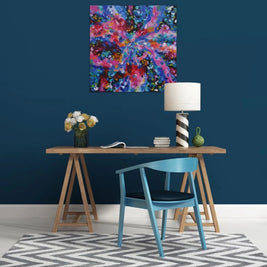 Modern interior with a colorful abstract painting on a blue wall, wooden table, and blue chair.