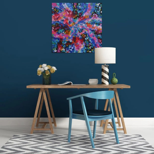 Modern interior with a colorful abstract painting on a blue wall, wooden table, and blue chair.