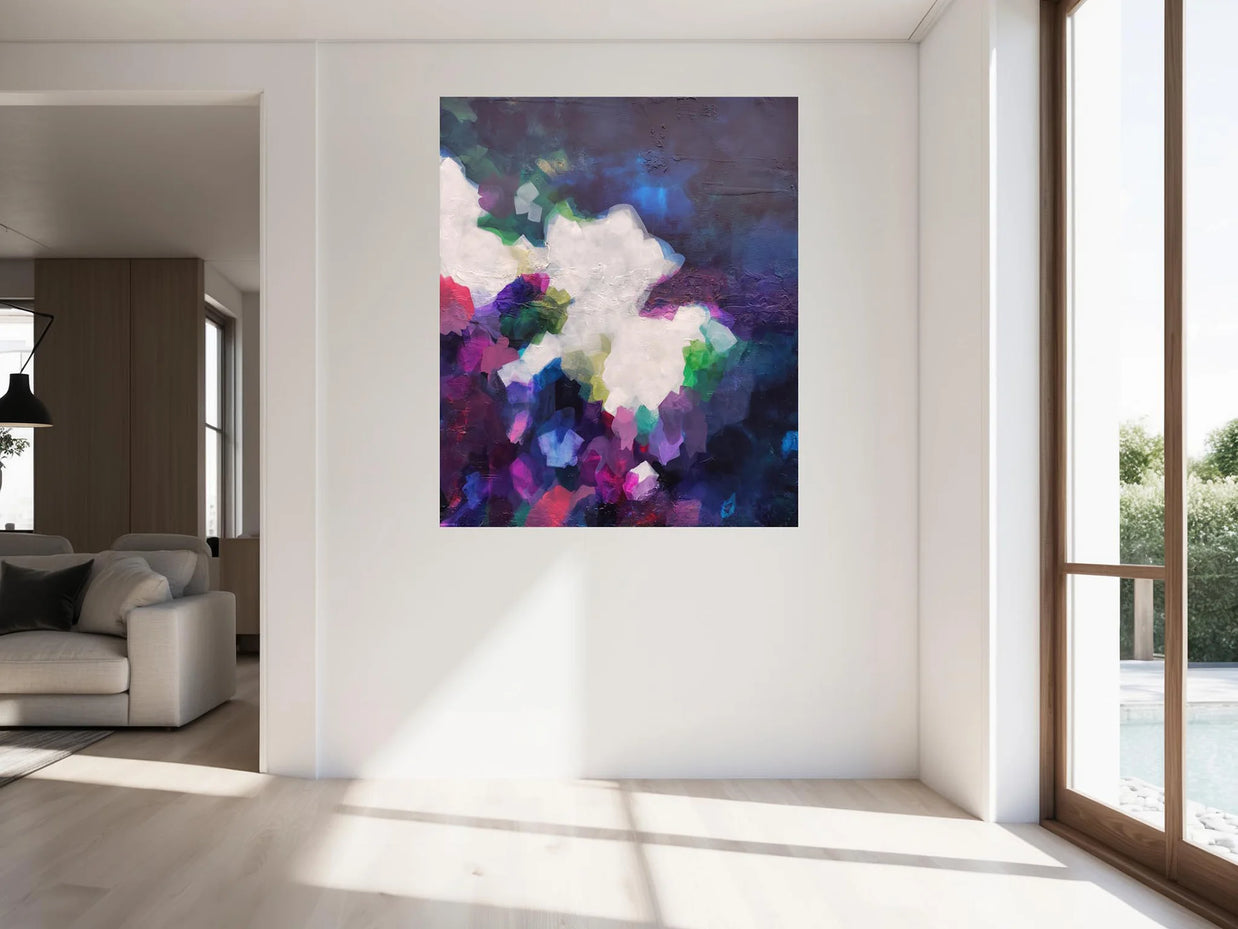 Colorful abstract painting on a white wall in a modern living room.