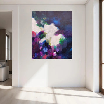 Colorful abstract painting on a white wall in a modern living room.