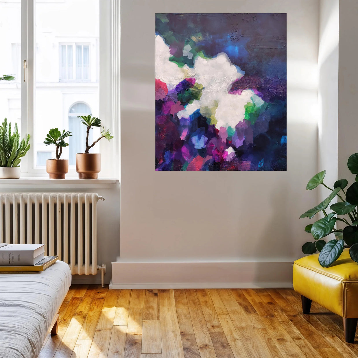 Living room with a colorful abstract painting on the wall, plants, and a yellow chair.