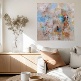 Living room with a sofa, coffee table, abstract painting, and decorative items.