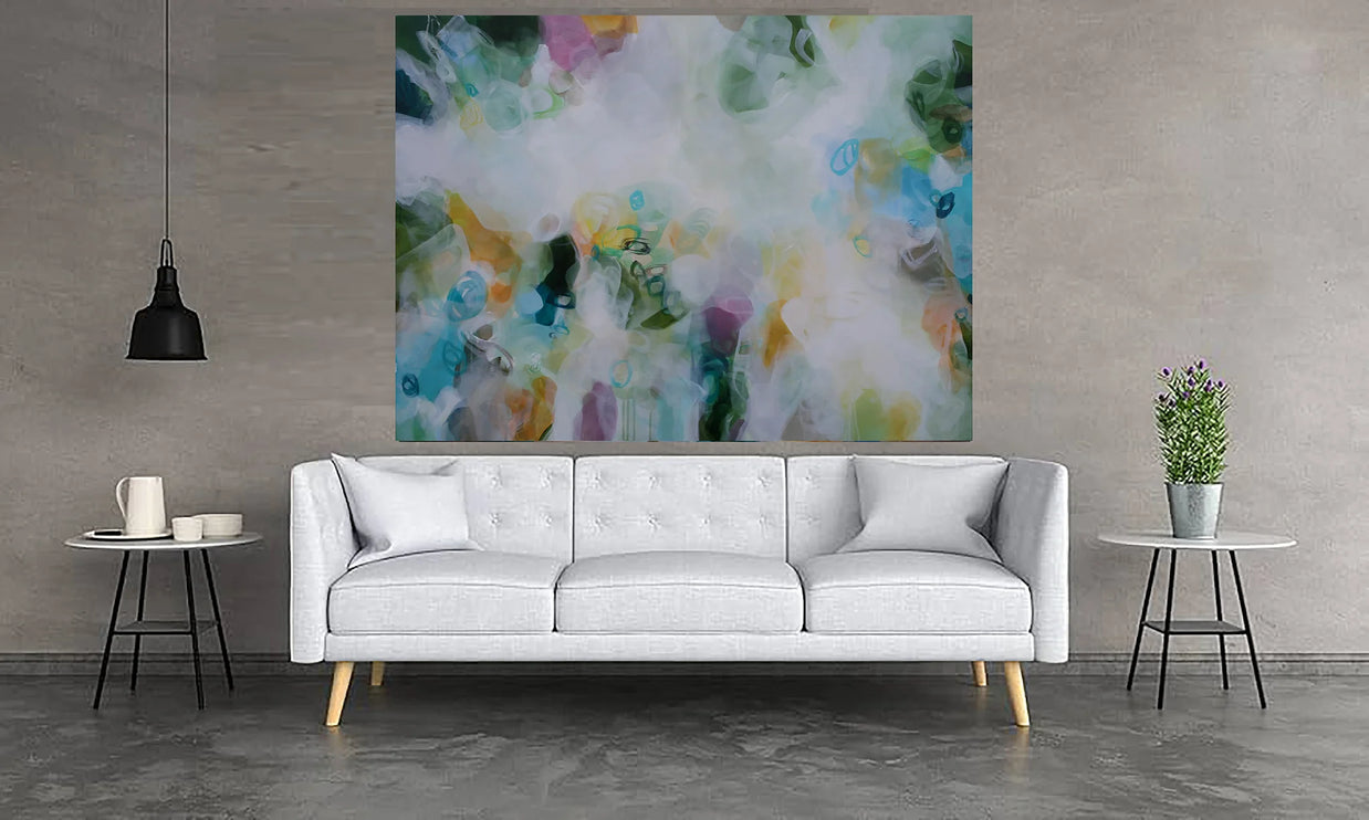 Modern living room with a white sofa, abstract painting, and side tables.