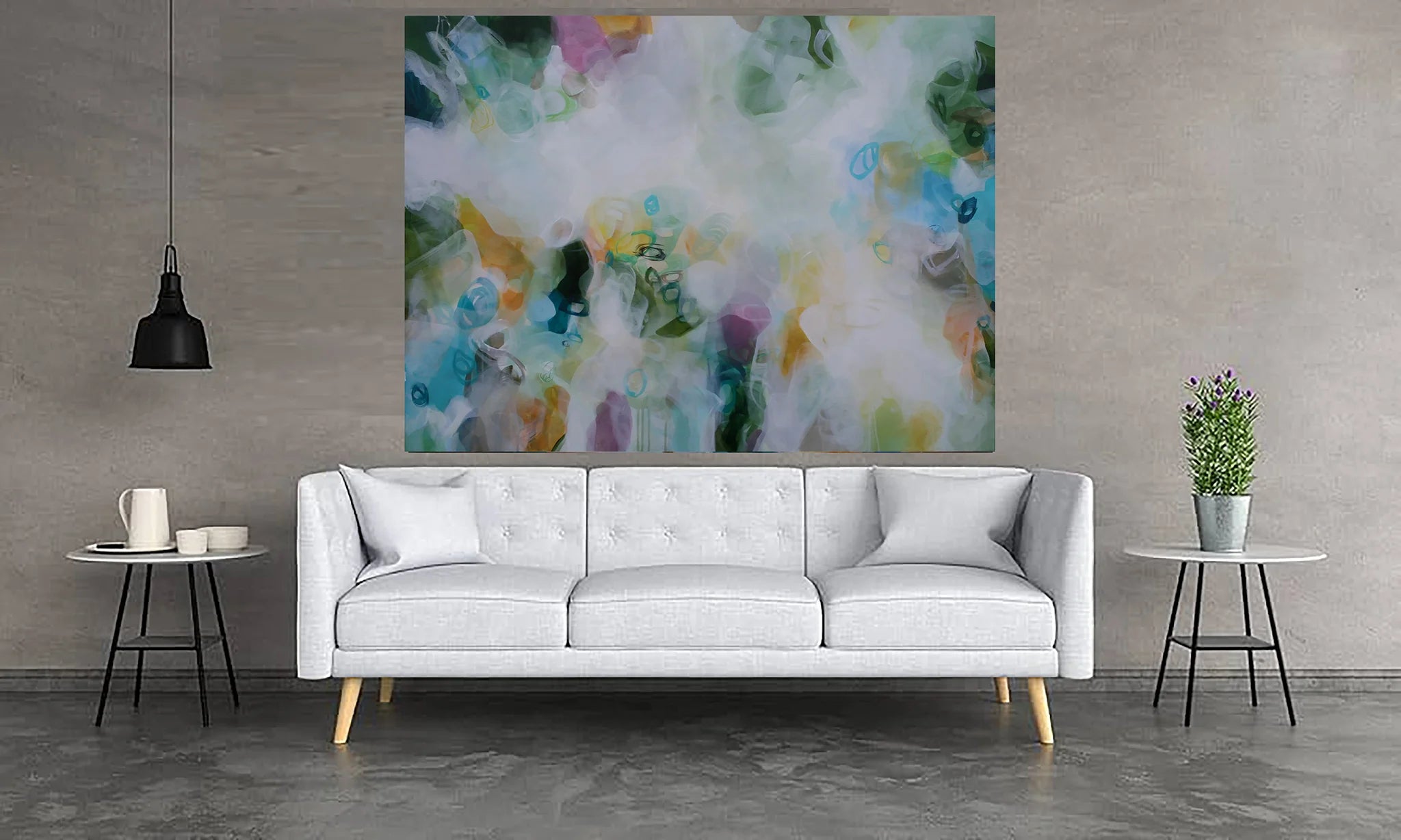 Modern living room with a white sofa, abstract painting, and side tables.