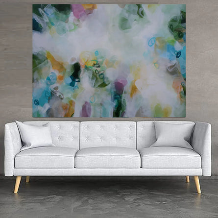 Modern living room with a white sofa, abstract painting, and side tables.