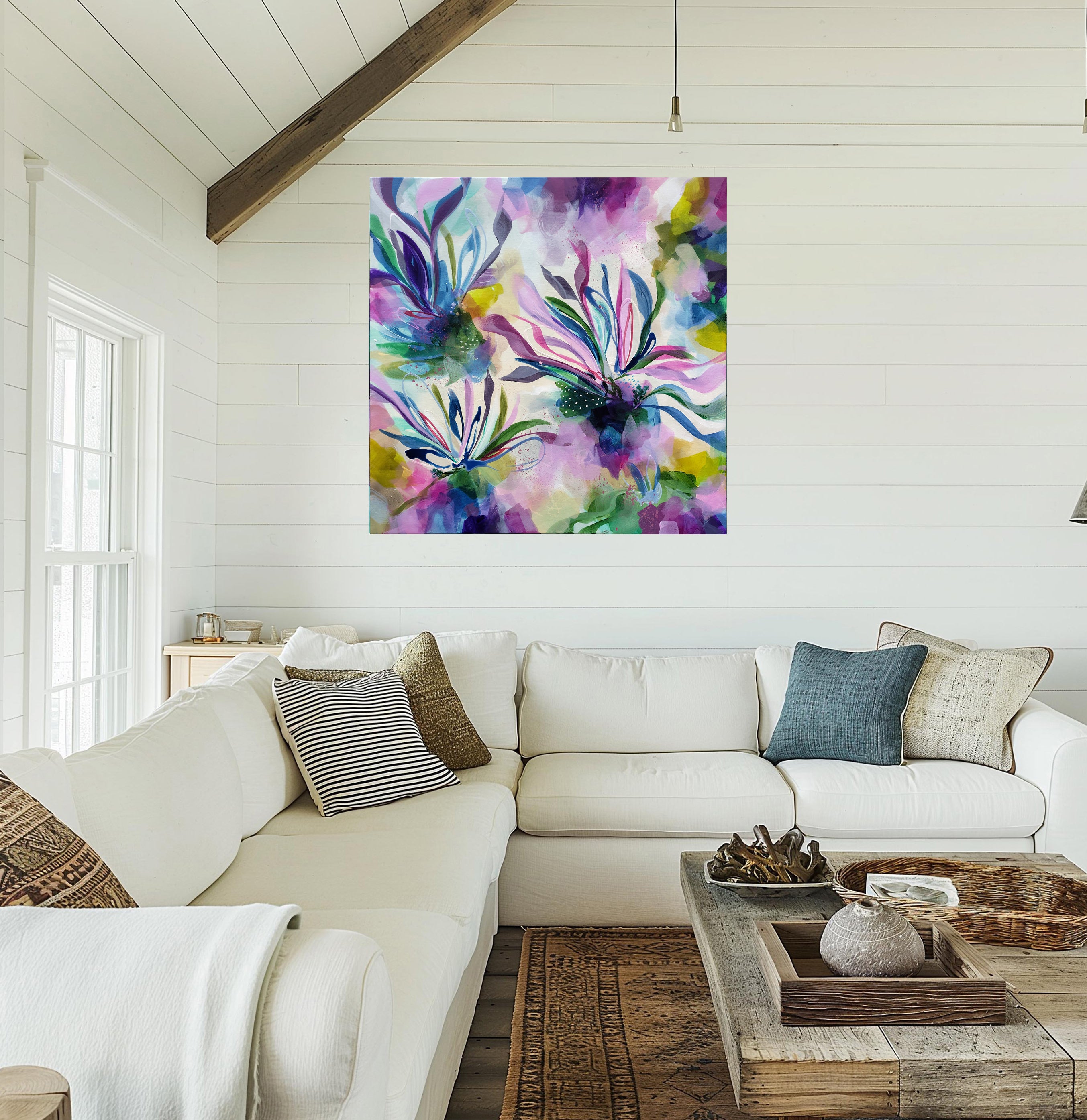 Living room with a colorful abstract painting above a white sofa.