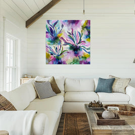 Living room with a colorful abstract painting above a white sofa.